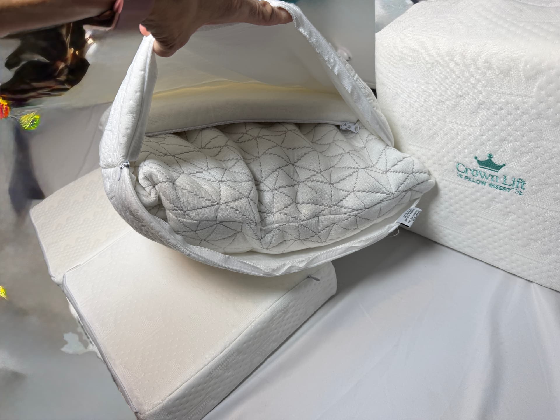 The Crown Lift pocket pillowcase held open, showing the pillow fill resting on the support core inside.