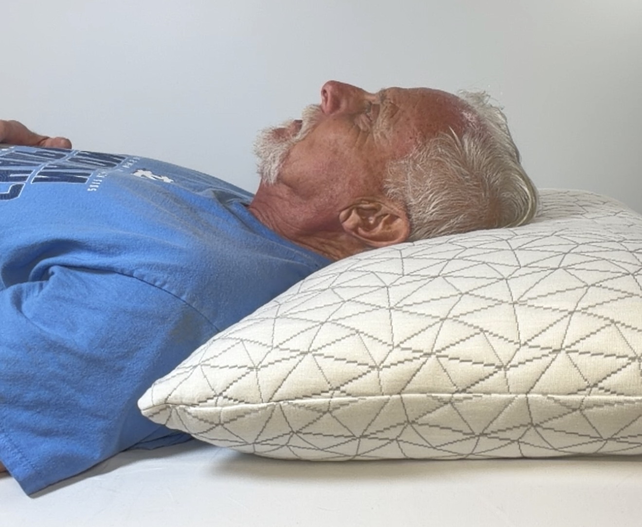Back sleeper resting on a supported pillow with CrownLift Insert®
