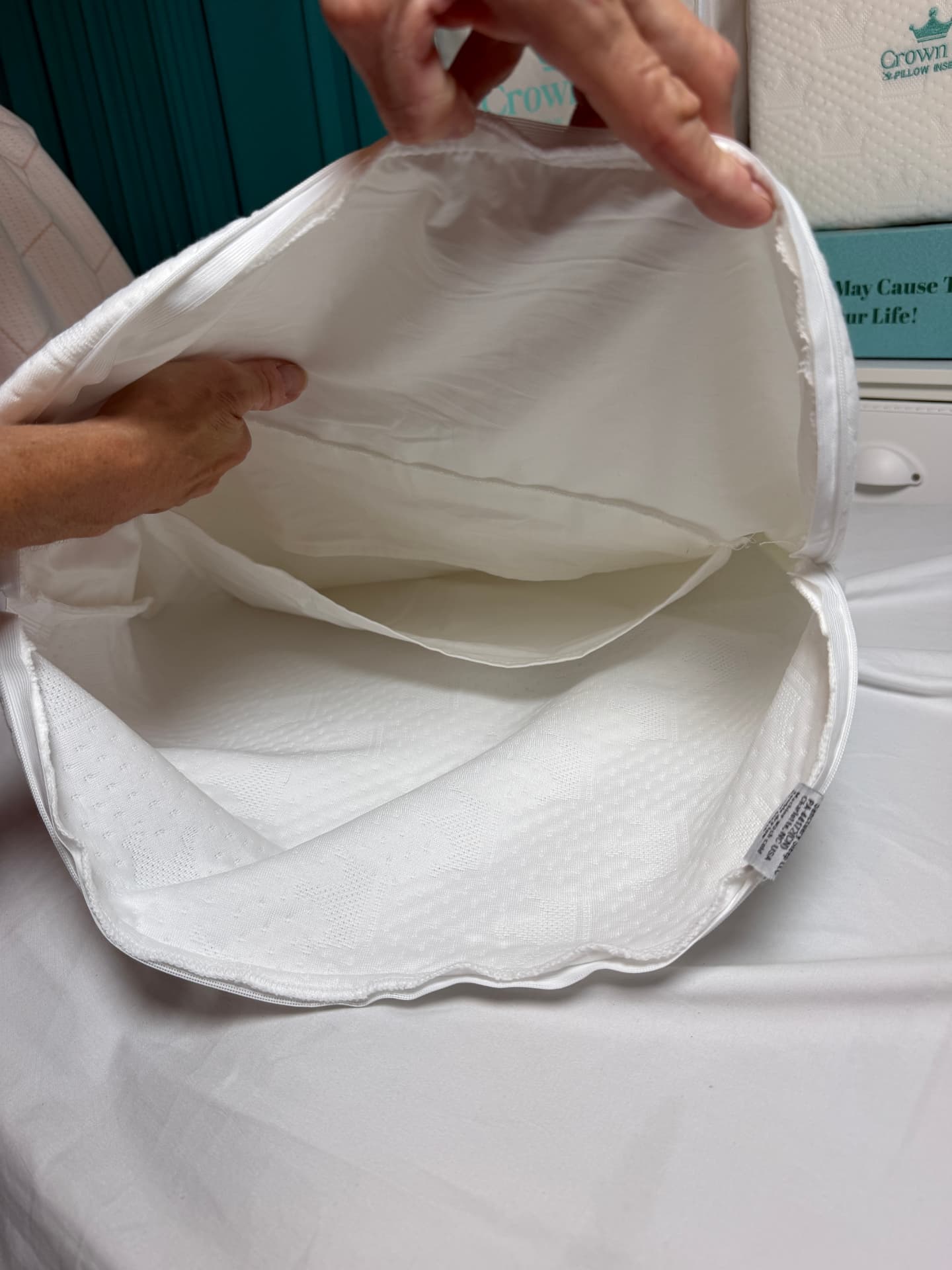 Hands holding open the inner pocket where the support core slides in