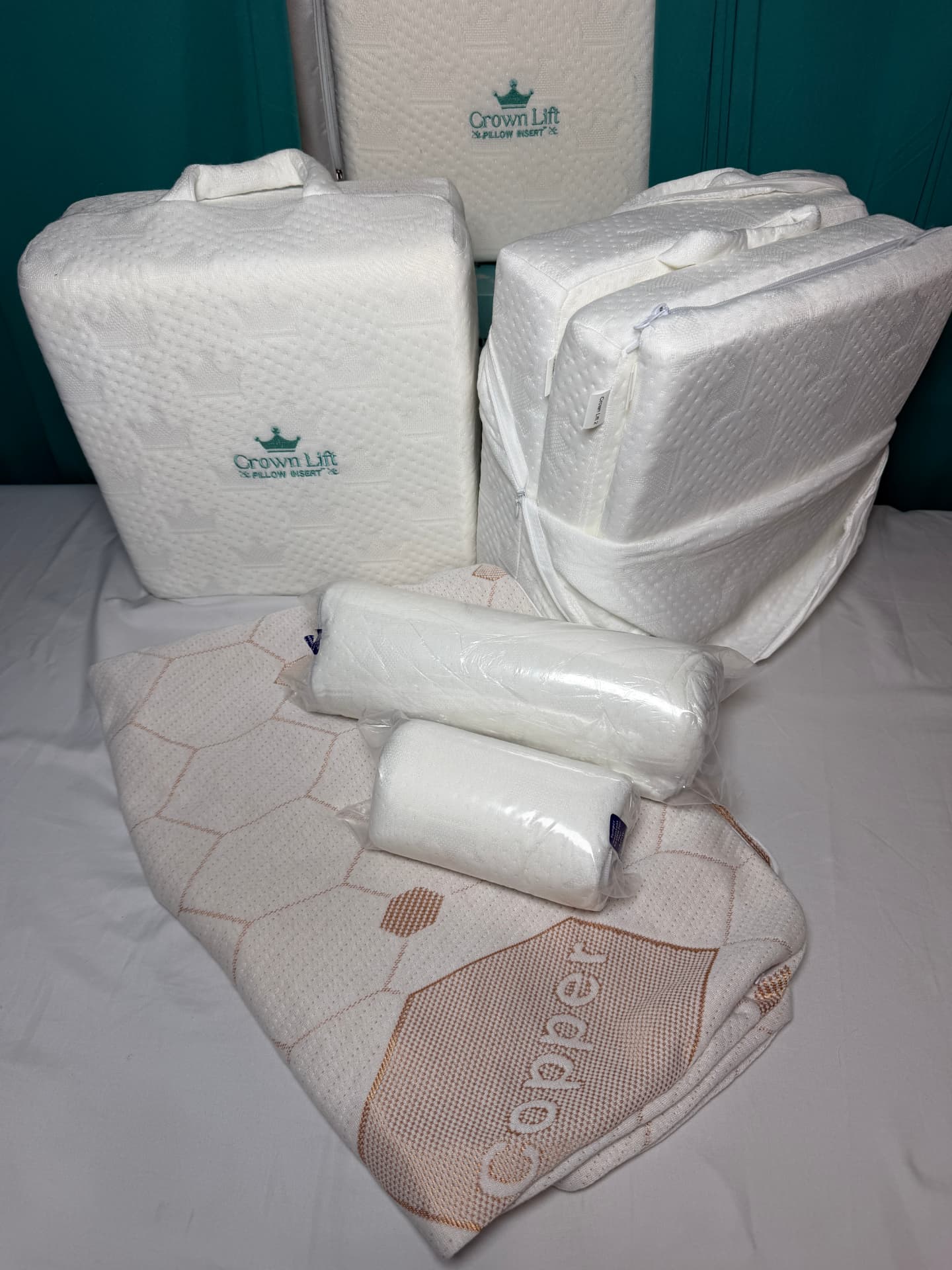 Crown Lift® Deluxe System with support inserts in storage cases, packaged accessories, and a copper pillowcase