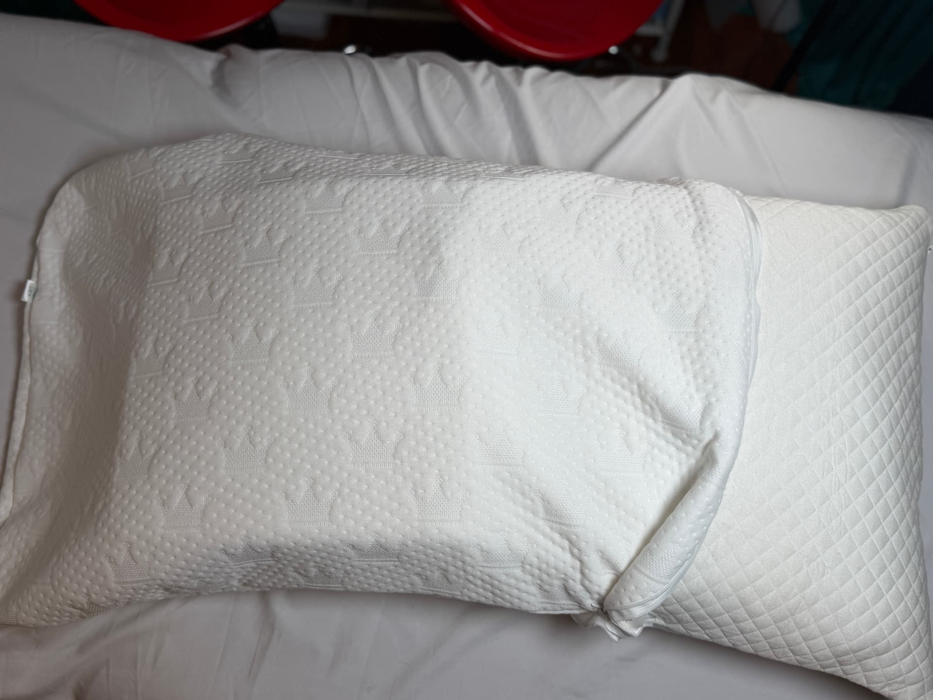 The Crown Lift pocket pillowcase closed on a bed, looking like a normal pillow.